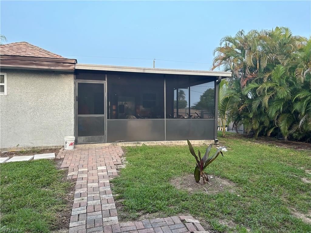 2049 50th Street Southwest Naples, FL 34116 - Photo 6 of 7 a house view with a garden space