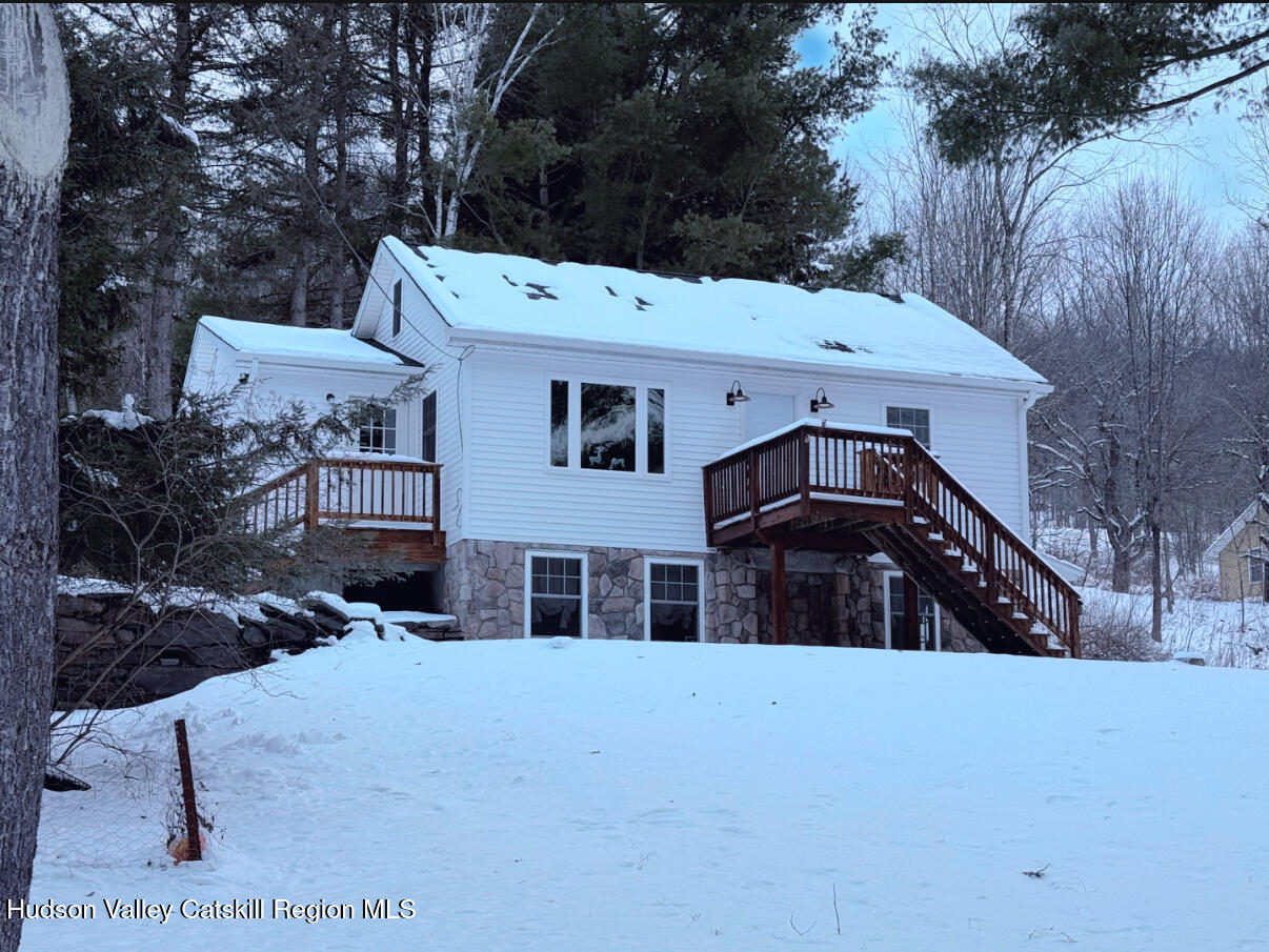 a view of a white house with a yard in the background