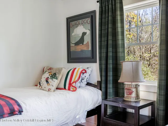 a bed sitting in a bedroom next to a window