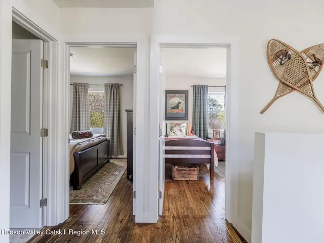a bedroom with furniture and a wooden floor