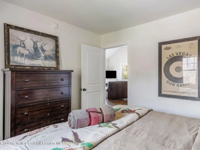 a bedroom with a bed and a television