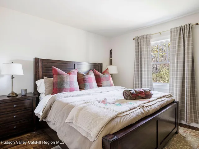 a bedroom with bed and a window