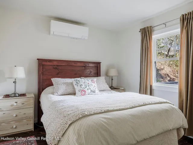 a large bed sitting in a bedroom next to a window