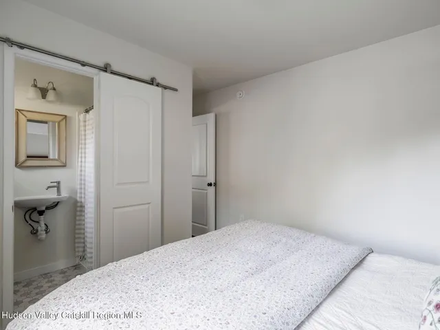 a bedroom with a bed and a mirror