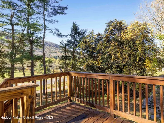 a view of a balcony with wooden floor and fence