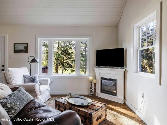 a living room with furniture a flat screen tv and a fireplace