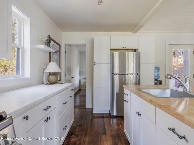 a kitchen with a refrigerator and a sink