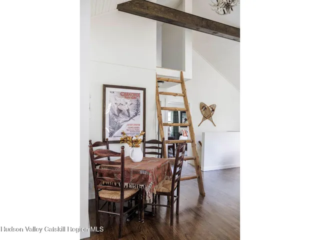 a dining room with furniture and wooden floor