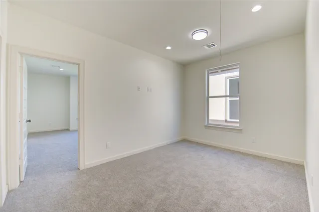an empty room with windows and closet