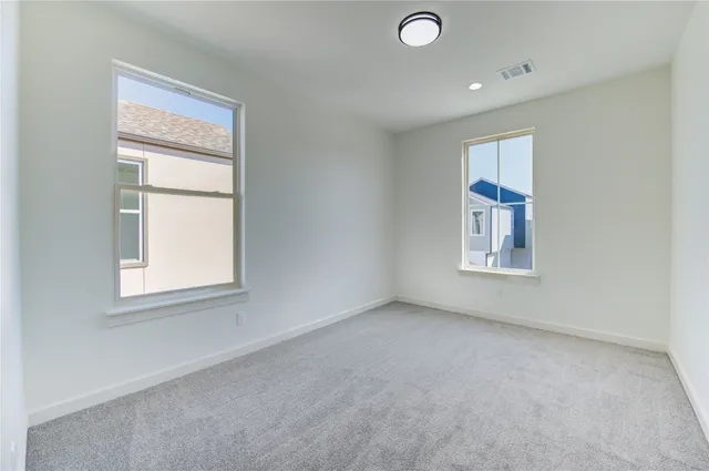 an empty room with windows and closet