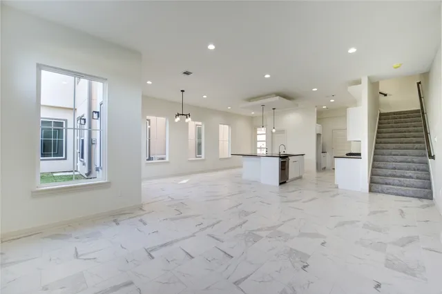a view of a big room with windows and a chandelier