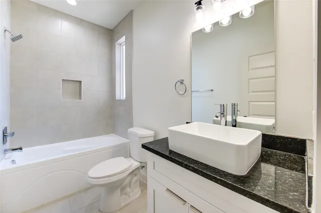 a bathroom with a sink a toilet and bathtub