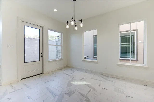 a view of a kitchen with refrigerator and windows