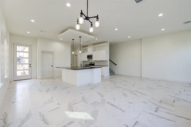 a view of kitchen with refrigerator and window