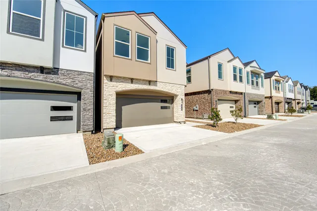 a view of a white house with large windows