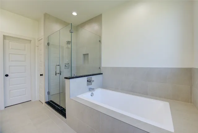 a bathroom with a bathtub and a shower