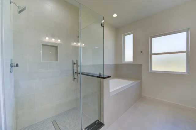 a bathroom with a bathtub and a shower