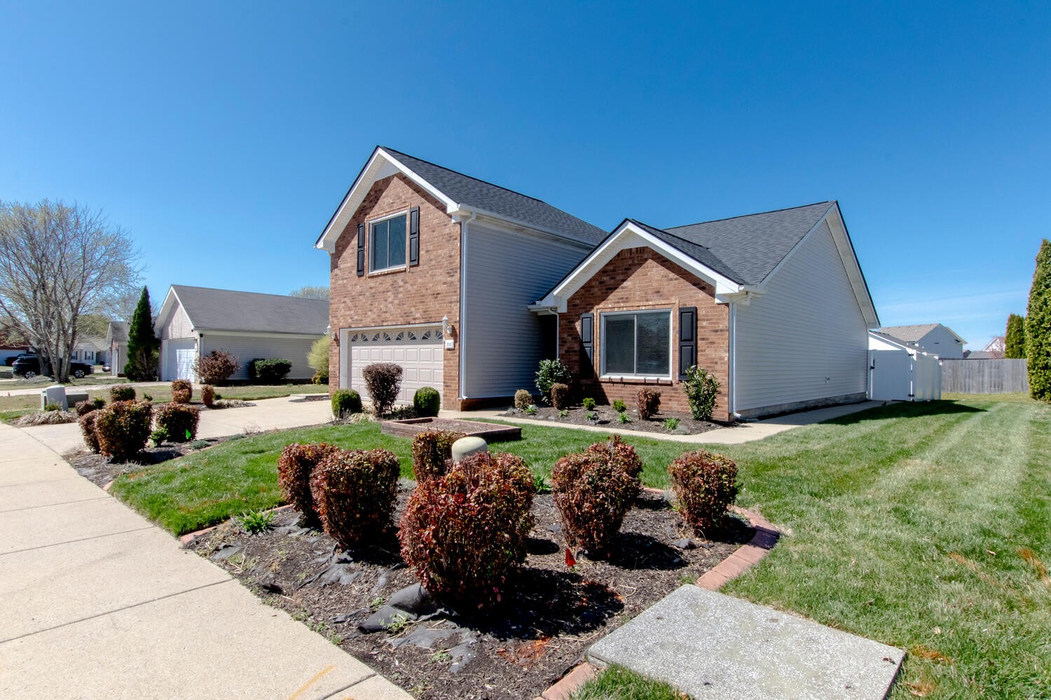 2112 Cason Trail Murfreesboro, TN 37128 - Photo 2 of 25 a front view of a house with a garden and yard
