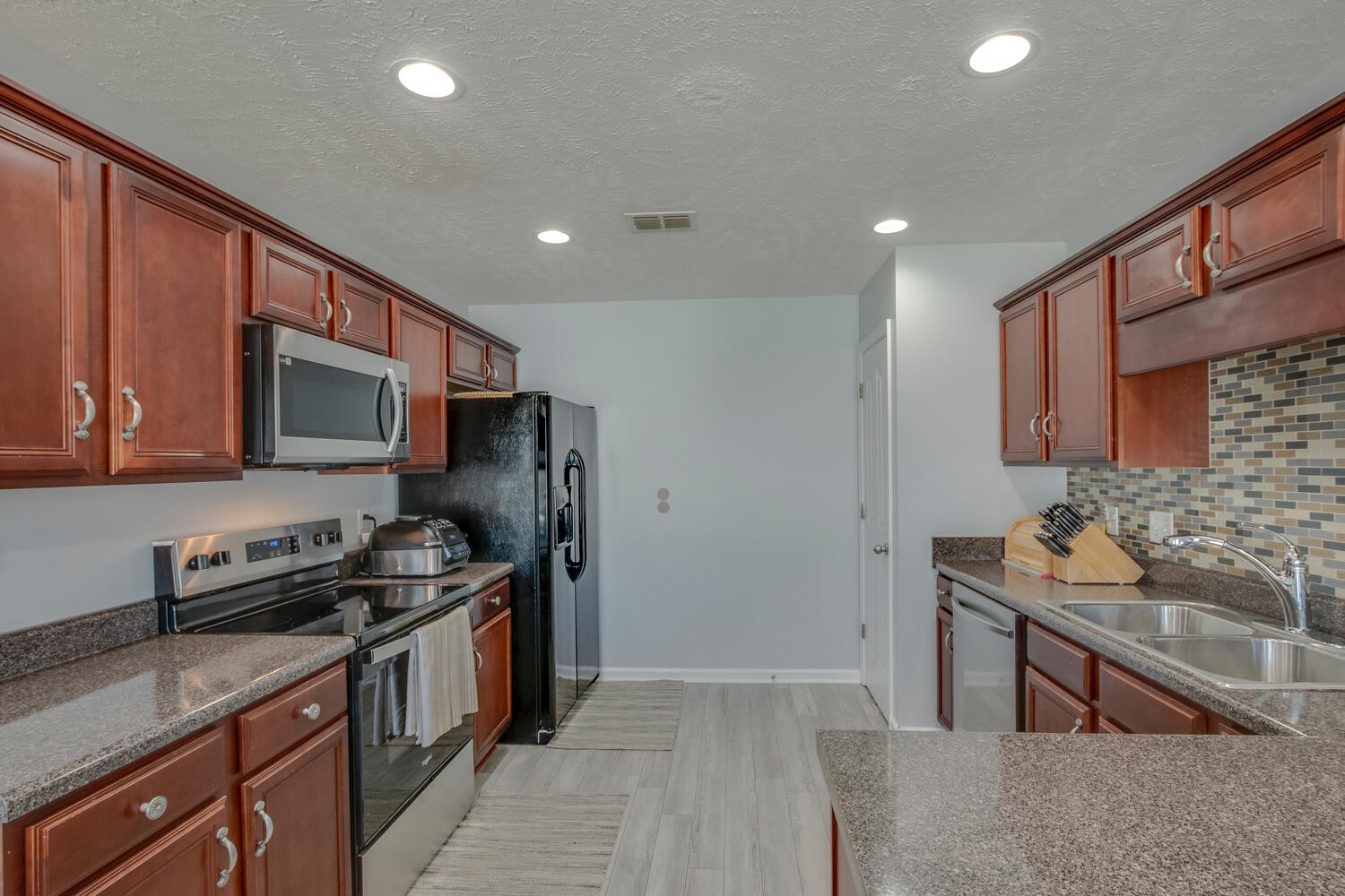 2112 Cason Trail Murfreesboro, TN 37128 - Photo 8 of 25 a kitchen with stainless steel appliances a stove sink and microwave