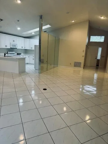 a view of a livingroom with kitchen and furniture