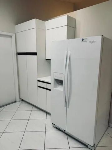 a kitchen with a sink and a washer dryer