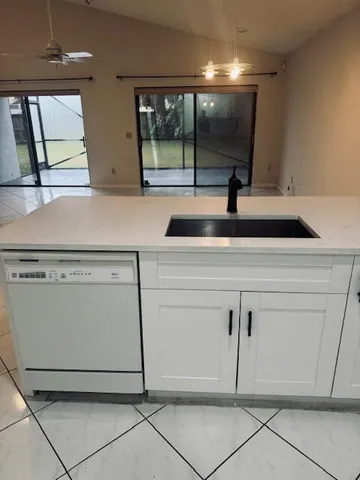 a kitchen with cabinets and white stainless steel appliances
