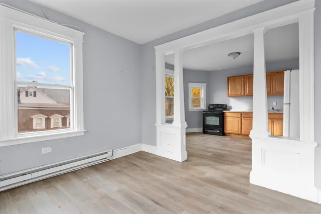a view of a kitchen with wooden floor and a kitchen