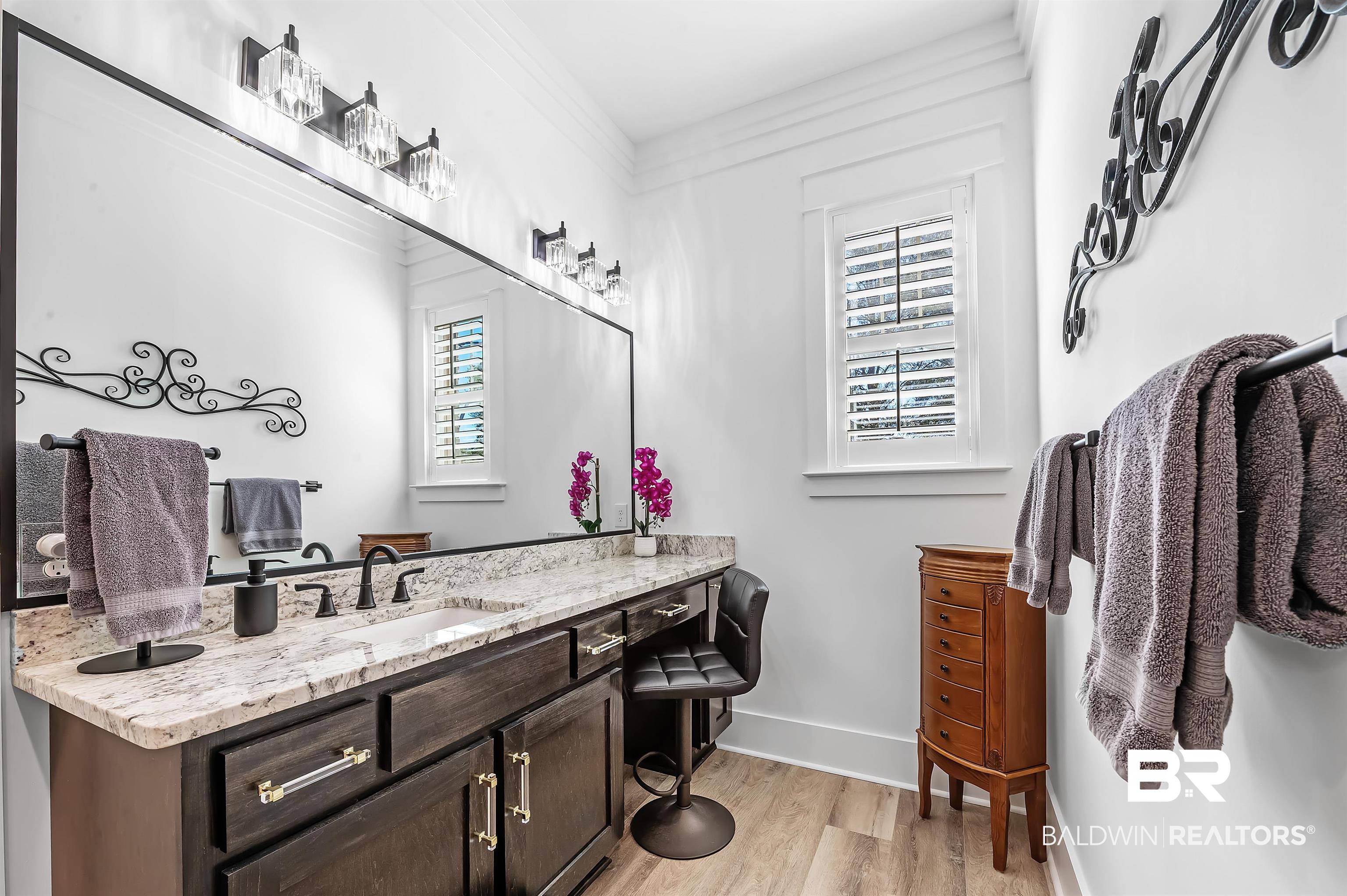 9144 Harvest Ridge Fairhope, AL 36532 - Photo 32 of 58 Bathroom featuring baseboards, crown molding, wood finished floors, and vanity