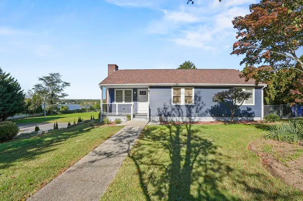 a view of a house with a yard and lake view