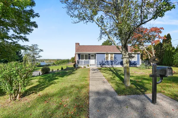 a view of a house with a big yard and potted plants