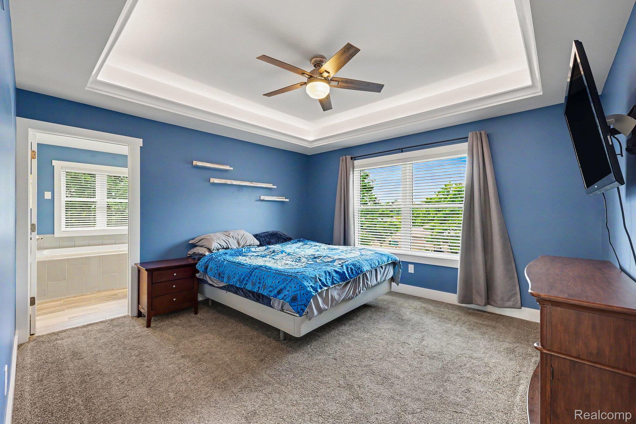 1660 Winthrop Road Bloomfield Hills, MI 48302 - Photo 19 of 38 Spacious room featuring a tray ceiling with crown molding, a ceiling fan, and carpet flooring
