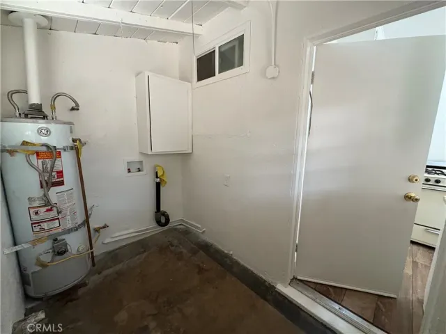 a view of storage and utility room with two washing machine