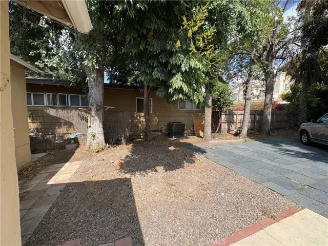 a view of a car park in front of a house