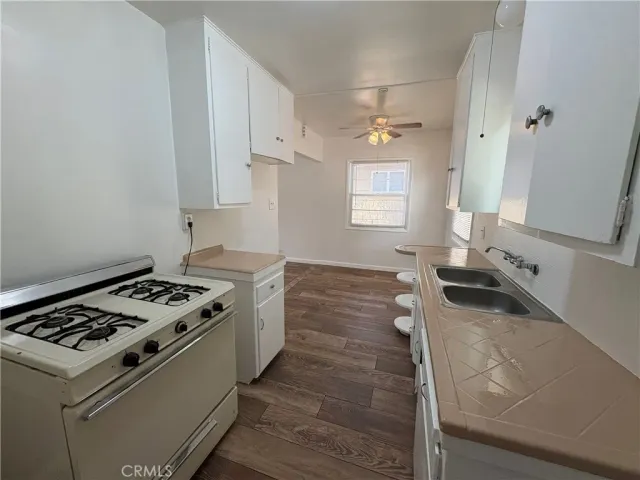 a kitchen with granite countertop a stove and a sink