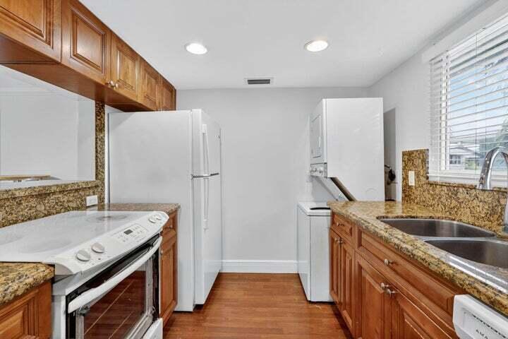 45 Southeast 7th Avenue, Unit 6 Delray Beach, FL 33483 - Photo 12 of 19 a kitchen with a sink stove and refrigerator