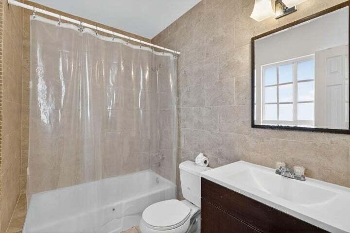 45 Southeast 7th Avenue, Unit 6 Delray Beach, FL 33483 - Photo 17 of 19 a bathroom with a sink toilet and shower