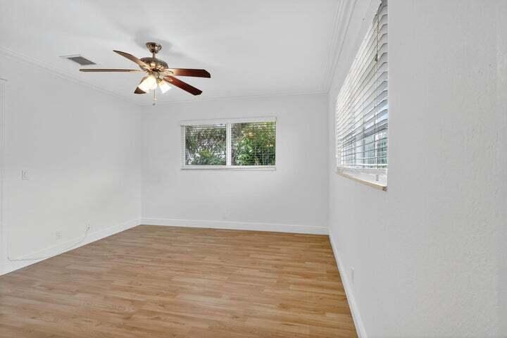 45 Southeast 7th Avenue, Unit 6 Delray Beach, FL 33483 - Photo 18 of 19 a view of a room with wooden floor and windows
