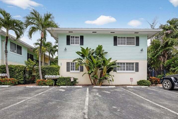 45 Southeast 7th Avenue, Unit 6 Delray Beach, FL 33483 - Photo 2 of 19 a house that has a palm tree in front of it