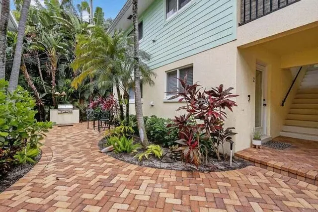 a couple of potted plants in front of door