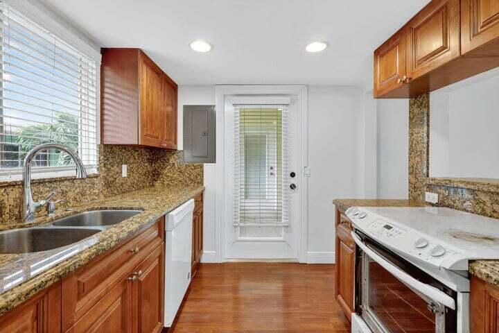 45 Southeast 7th Avenue, Unit 6 Delray Beach, FL 33483 - Photo 8 of 19 a kitchen that has a sink and a stove