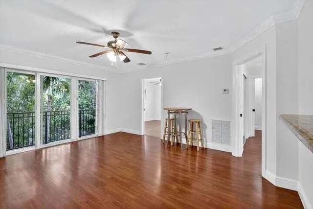 a view of a work space with wooden floor and a kitchen