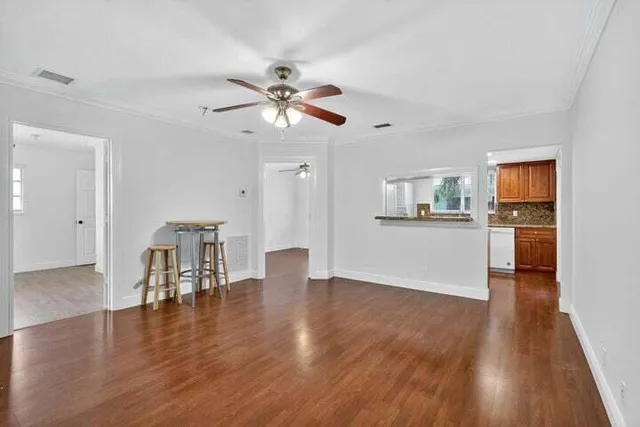 a view of kitchen with livingroom and wooden floor