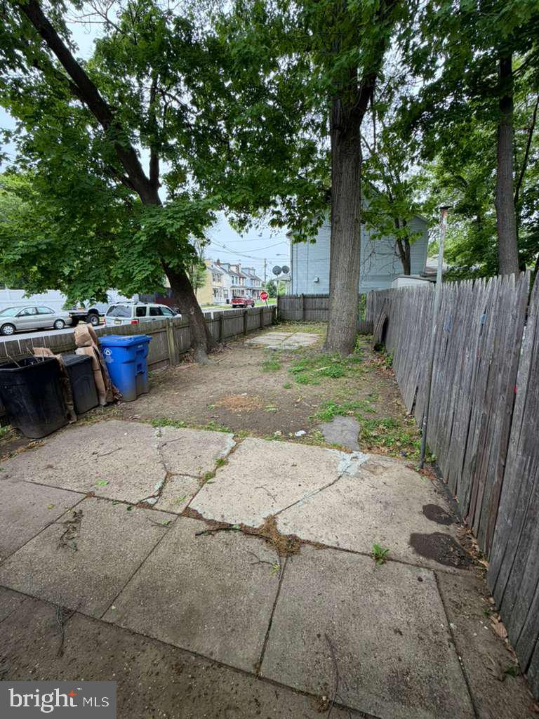 231 Broad Street, Unit B Beverly, NJ 08010 - Photo 2 of 9 a view of a backyard with potted plants and large trees