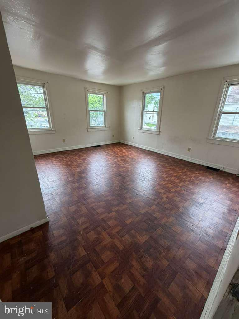 231 Broad Street, Unit B Beverly, NJ 08010 - Photo 3 of 9 an empty room with windows