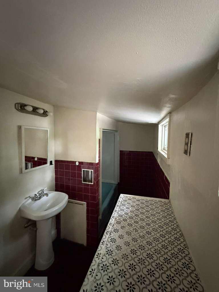 231 Broad Street, Unit B Beverly, NJ 08010 - Photo 7 of 9 a bathroom with a sink and a mirror