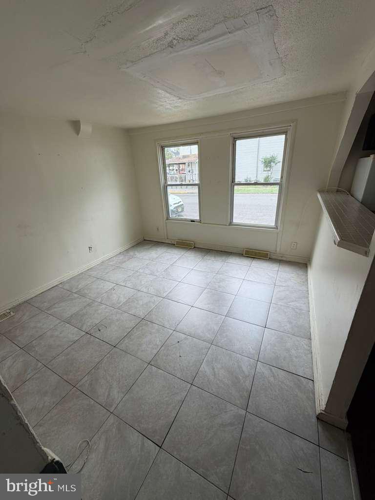 231 Broad Street, Unit B Beverly, NJ 08010 - Photo 9 of 9 a view of an empty room with a window