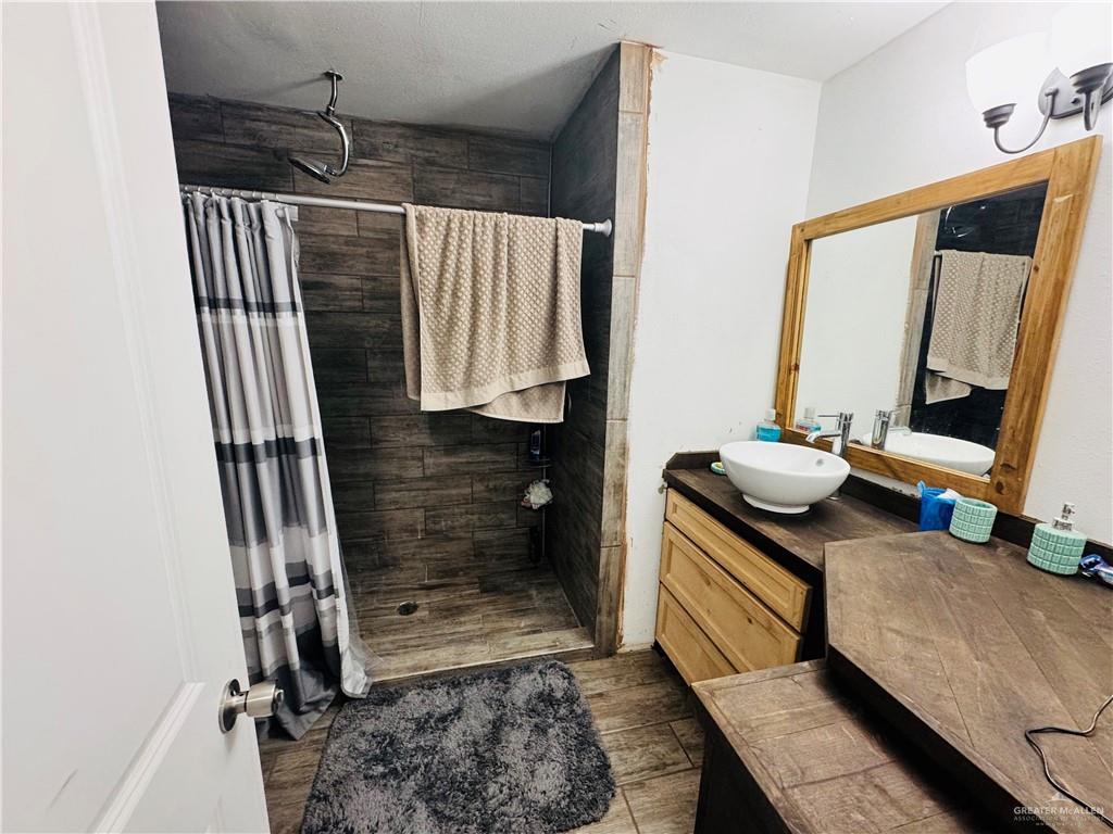 22417 Carrizales Road, Unit SERVICE Edinburg, TX 78542 - Photo 12 of 28 a bathroom with a sink and a mirror