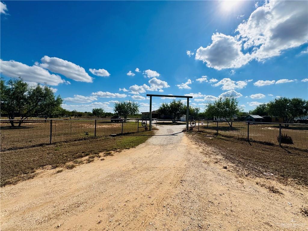 22417 Carrizales Road, Unit SERVICE Edinburg, TX 78542 - Photo 23 of 28 a view of a yard with wooden fence