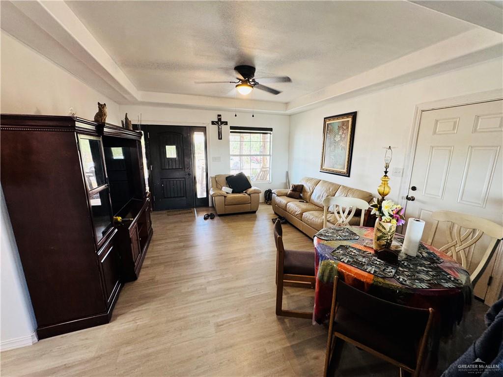 22417 Carrizales Road, Unit SERVICE Edinburg, TX 78542 - Photo 4 of 28 a living room with furniture and a flat screen tv