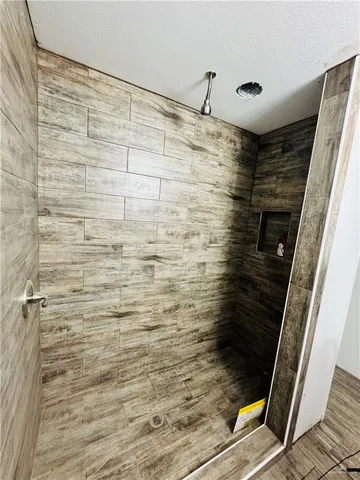 a bedroom with two beds and a flat screen tv